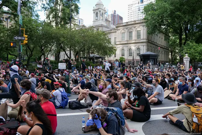 A photo of protesters sitting at City Hall during a protest in June 2020
